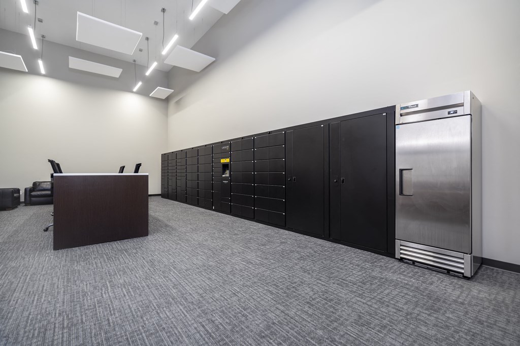 a large room with lockers and a desk in it