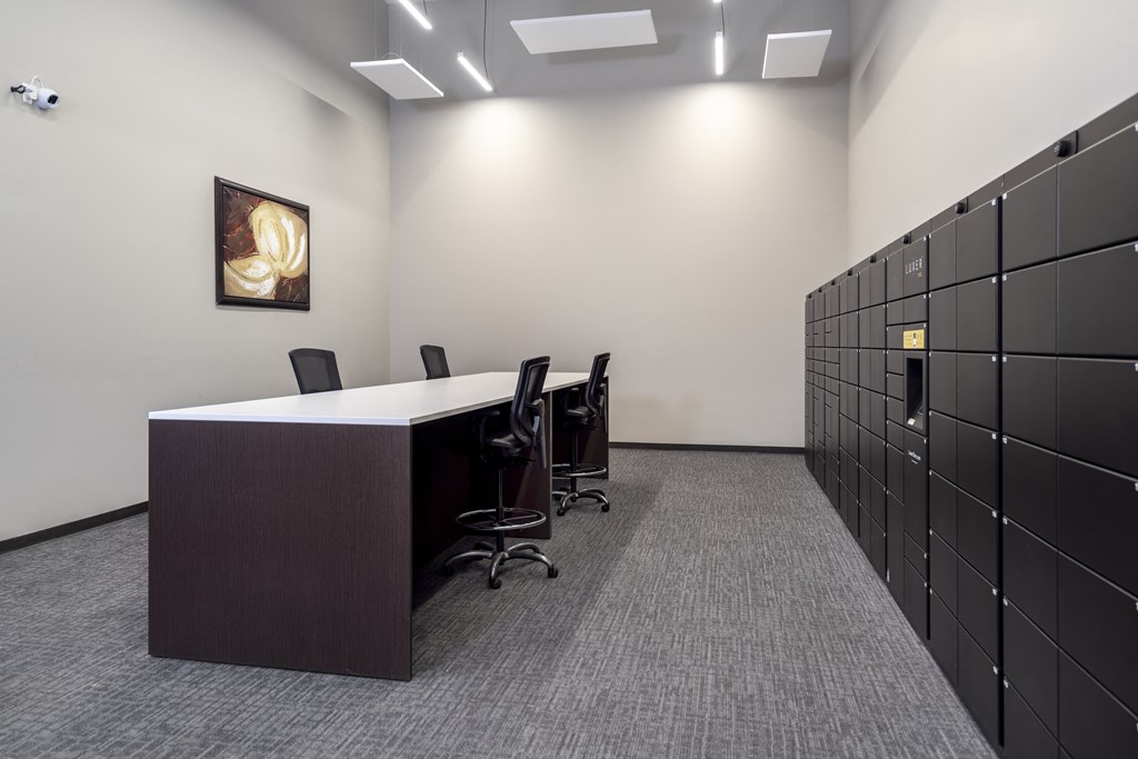 an office with a long desk and a row of lockers