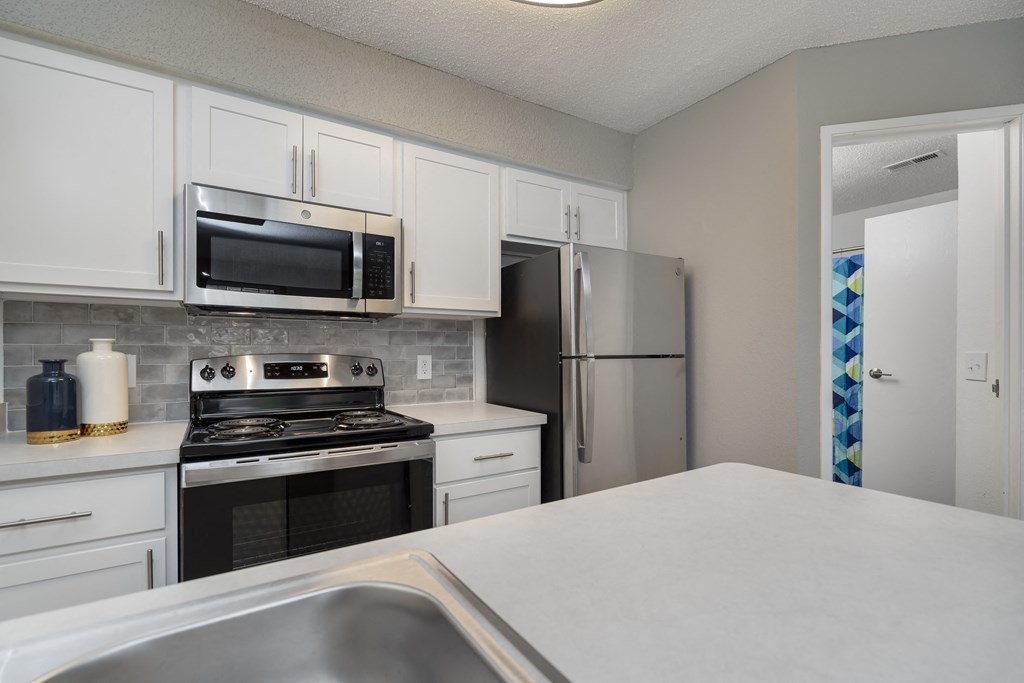 the preserve at ballantyne commons kitchen with stainless steel appliances and white cabinets