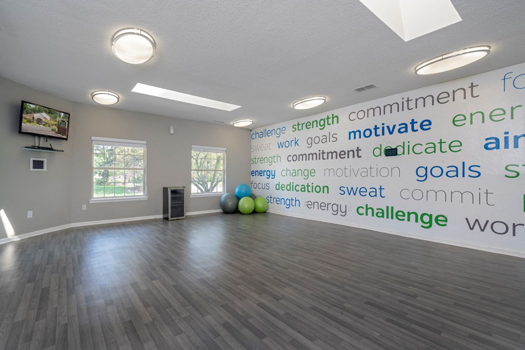 a large room with a wall with words on the wall and a dance floor