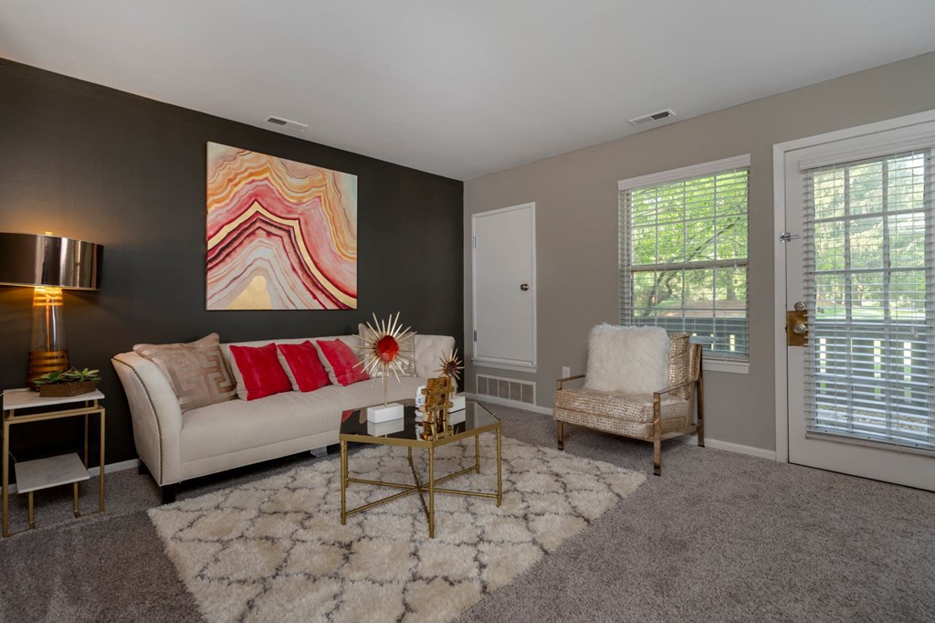 a living room with a couch and a chair and a table