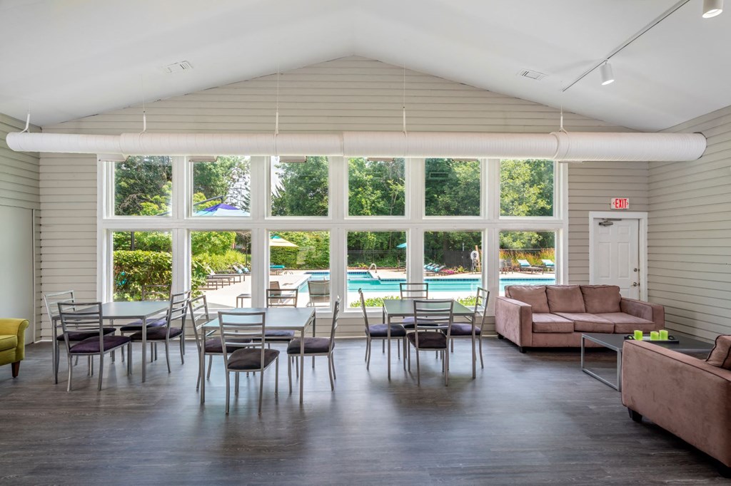 a large room with tables and chairs and large windows