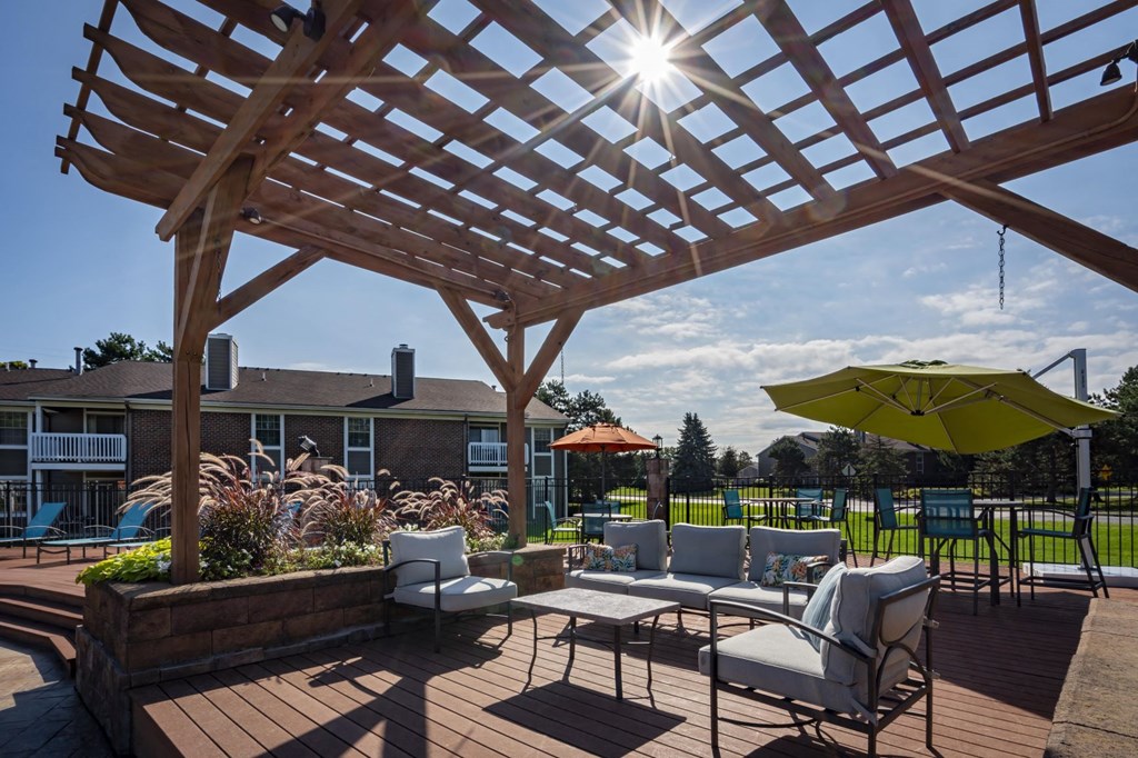 a covered patio with chairs and umbrellas