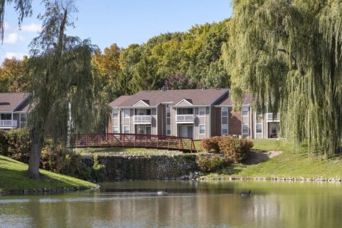 a building next to a lake with a bridge