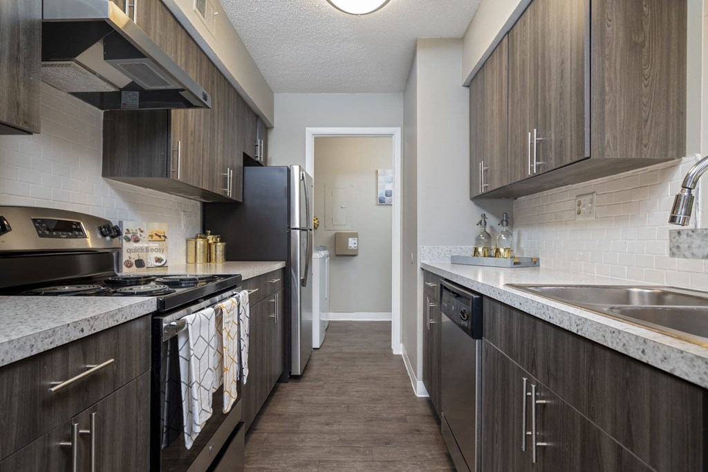 a kitchen with wooden cabinets and stainless steel appliances