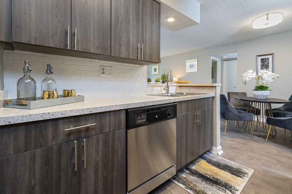 an open kitchen with stainless steel appliances and a counter top