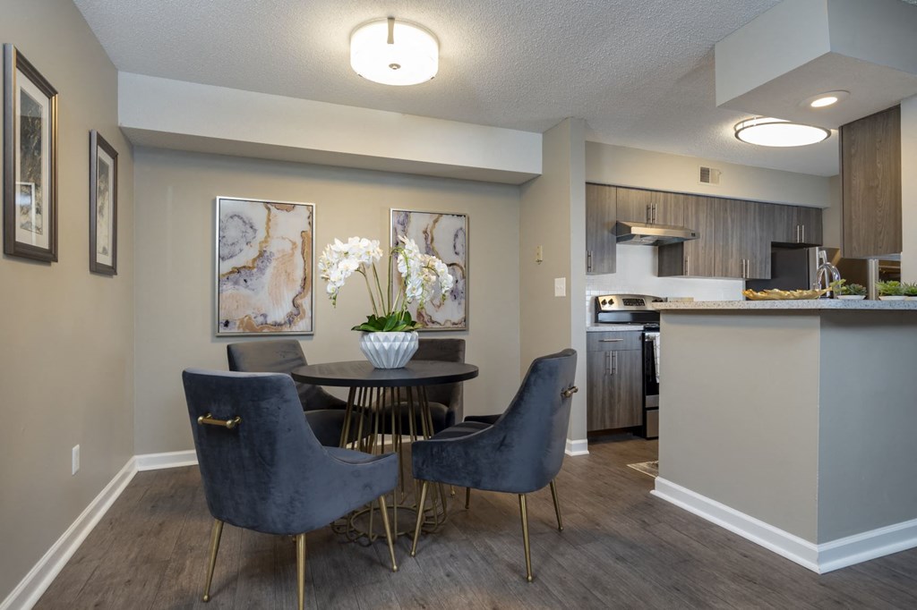 a dining room and kitchen with a table and chairs