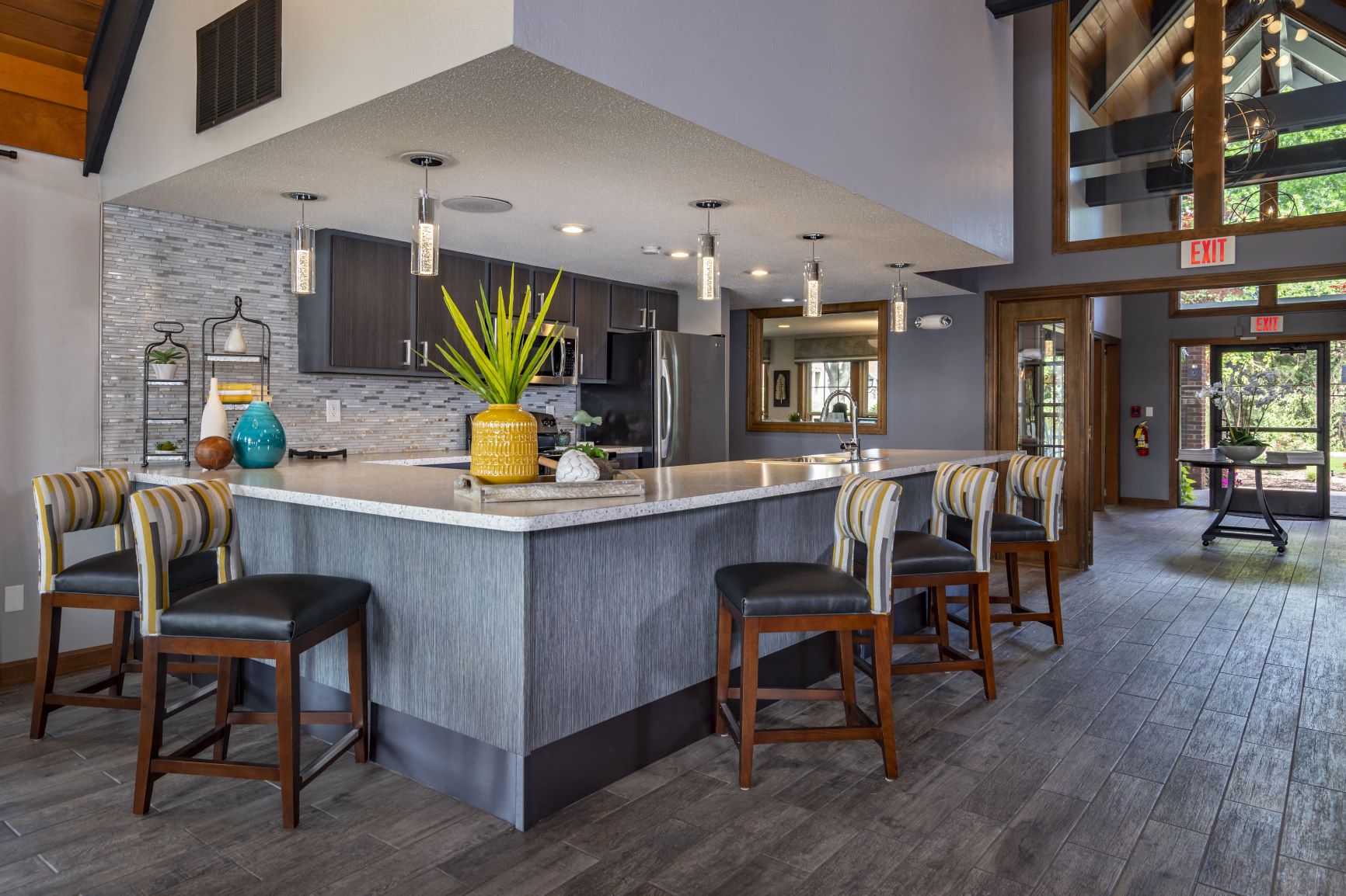 a large kitchen with a counter and chairs