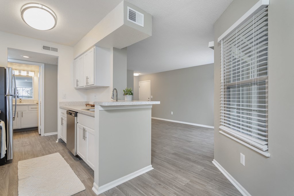an open kitchen and living room with a large window