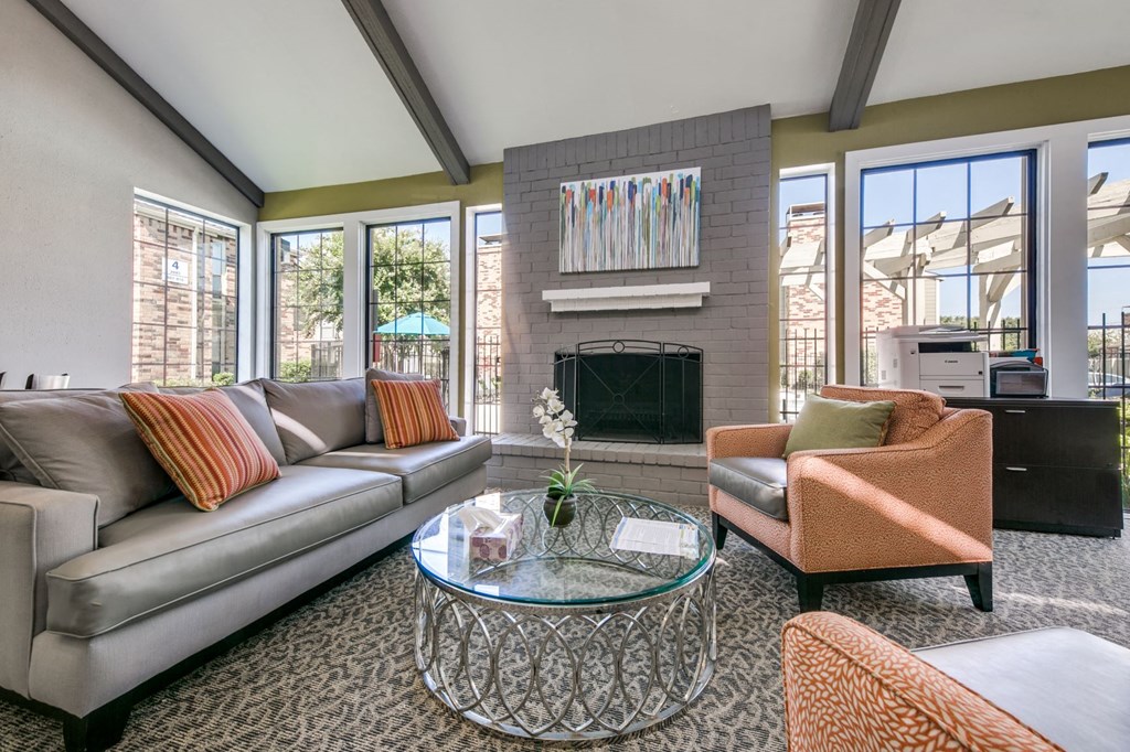 a living room with couches and chairs and a fireplace