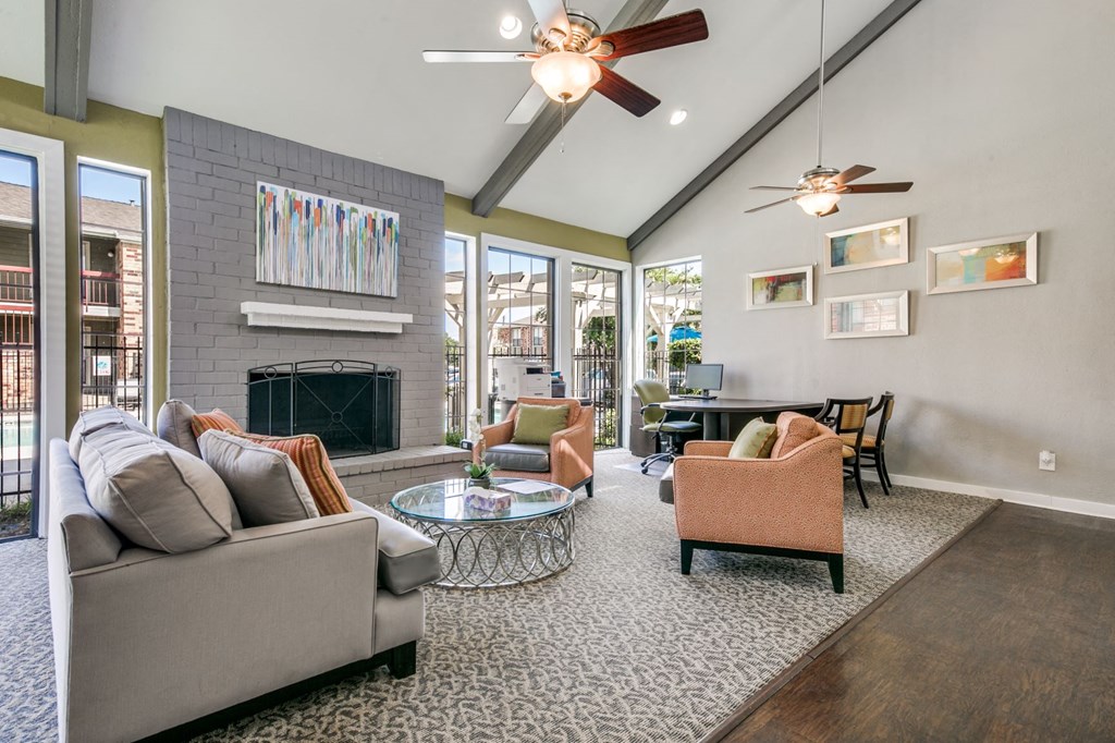 a living room with couches and chairs and a fireplace