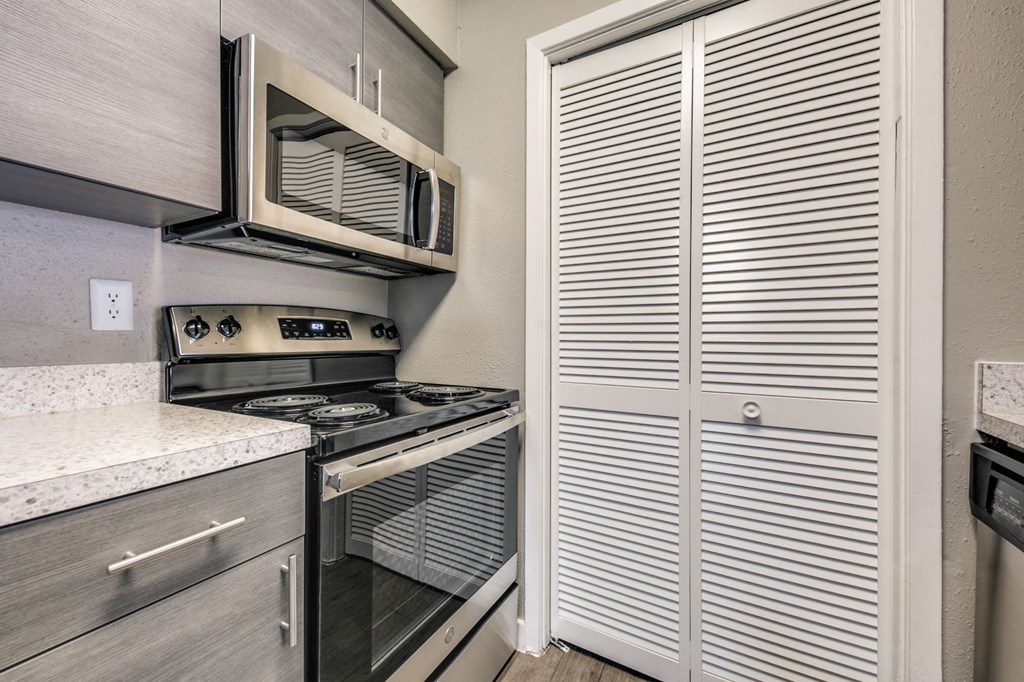 a kitchen with a stove and a microwave and a refrigerator