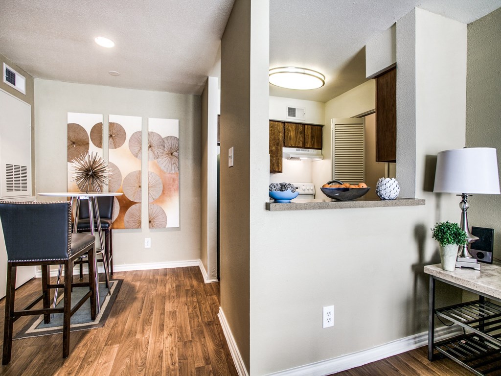 an open living room and kitchen with a dining room table and chairs