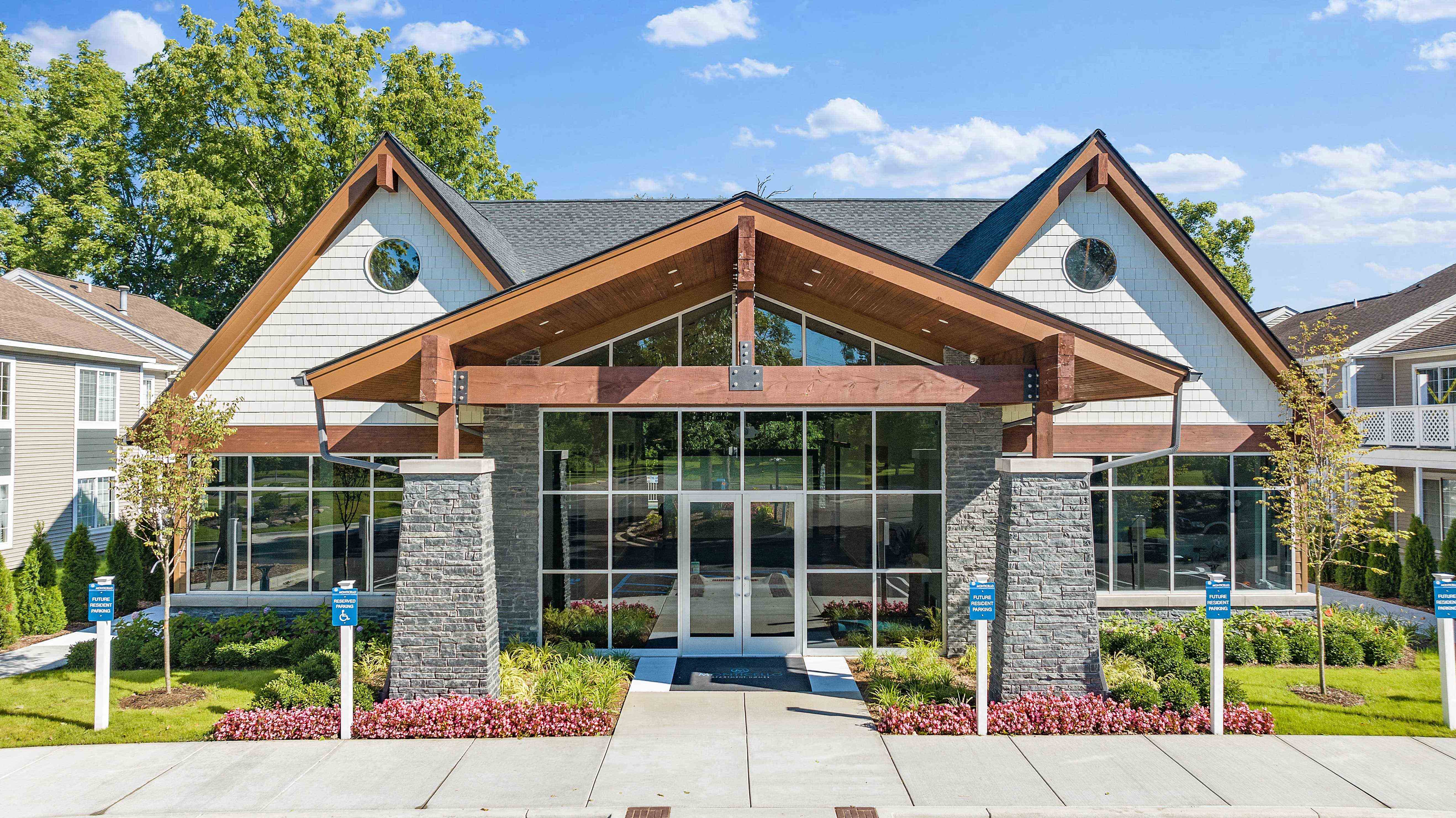 the front of a building with glass windows and a porch