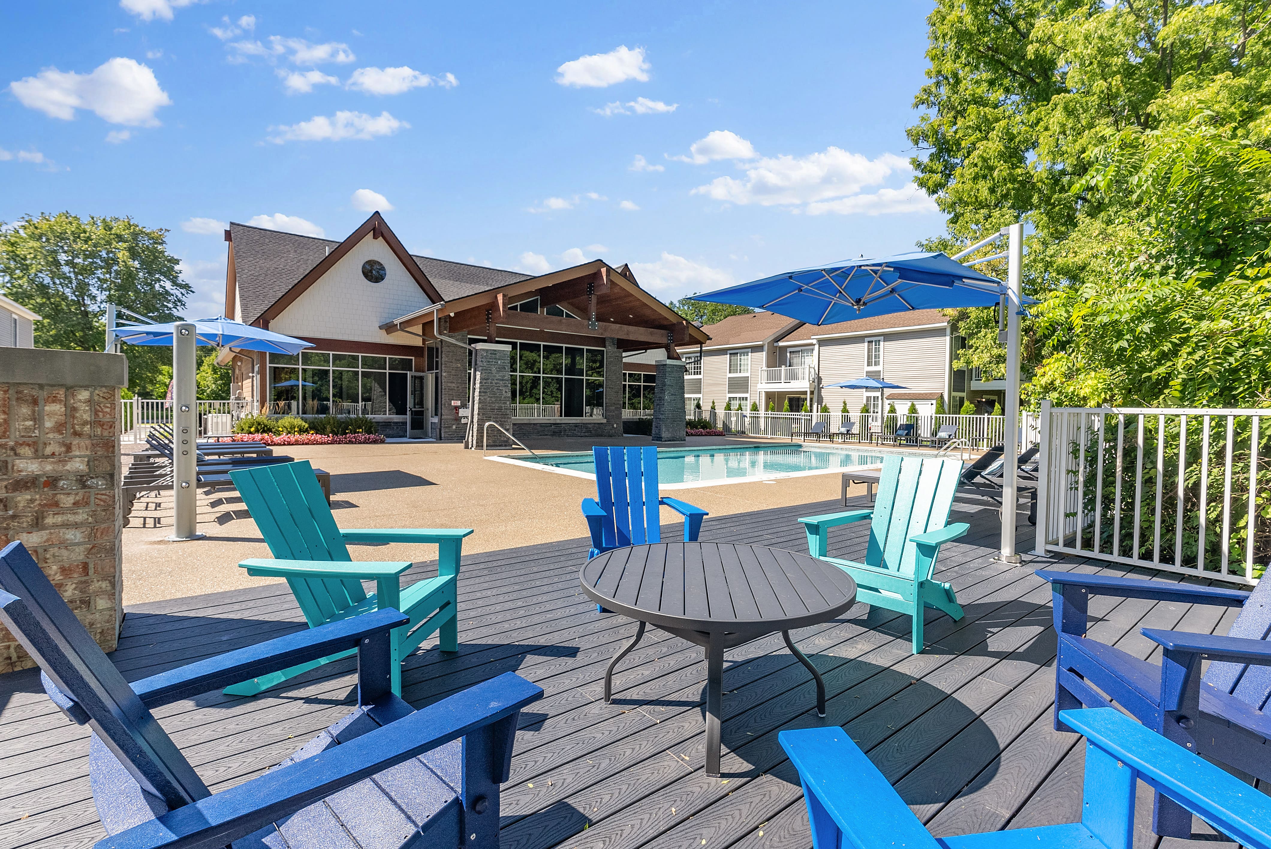 our apartments have a large patio with chairs and a pool