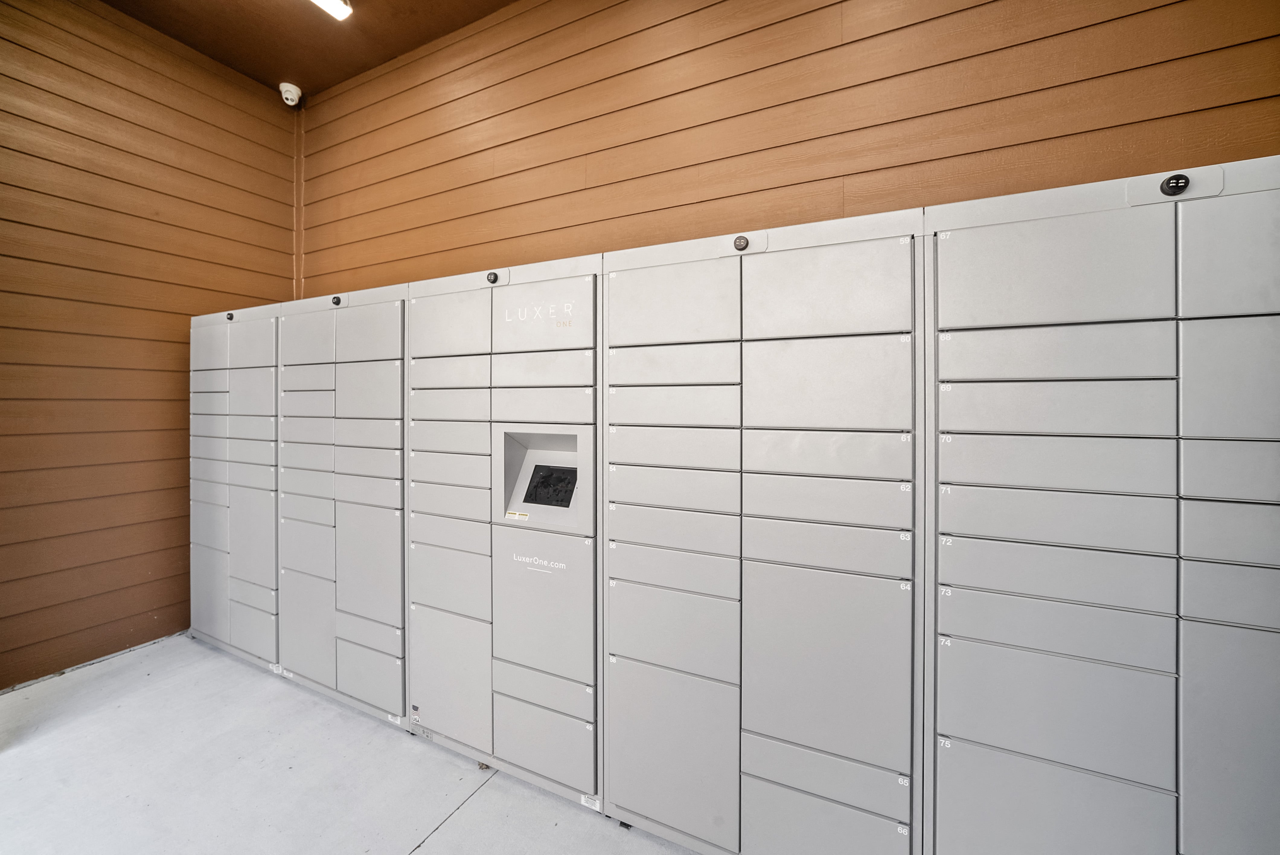 a bunch of white lockers in a room with wooden walls