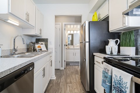 a kitchen with stainless steel appliances and white cabinets
