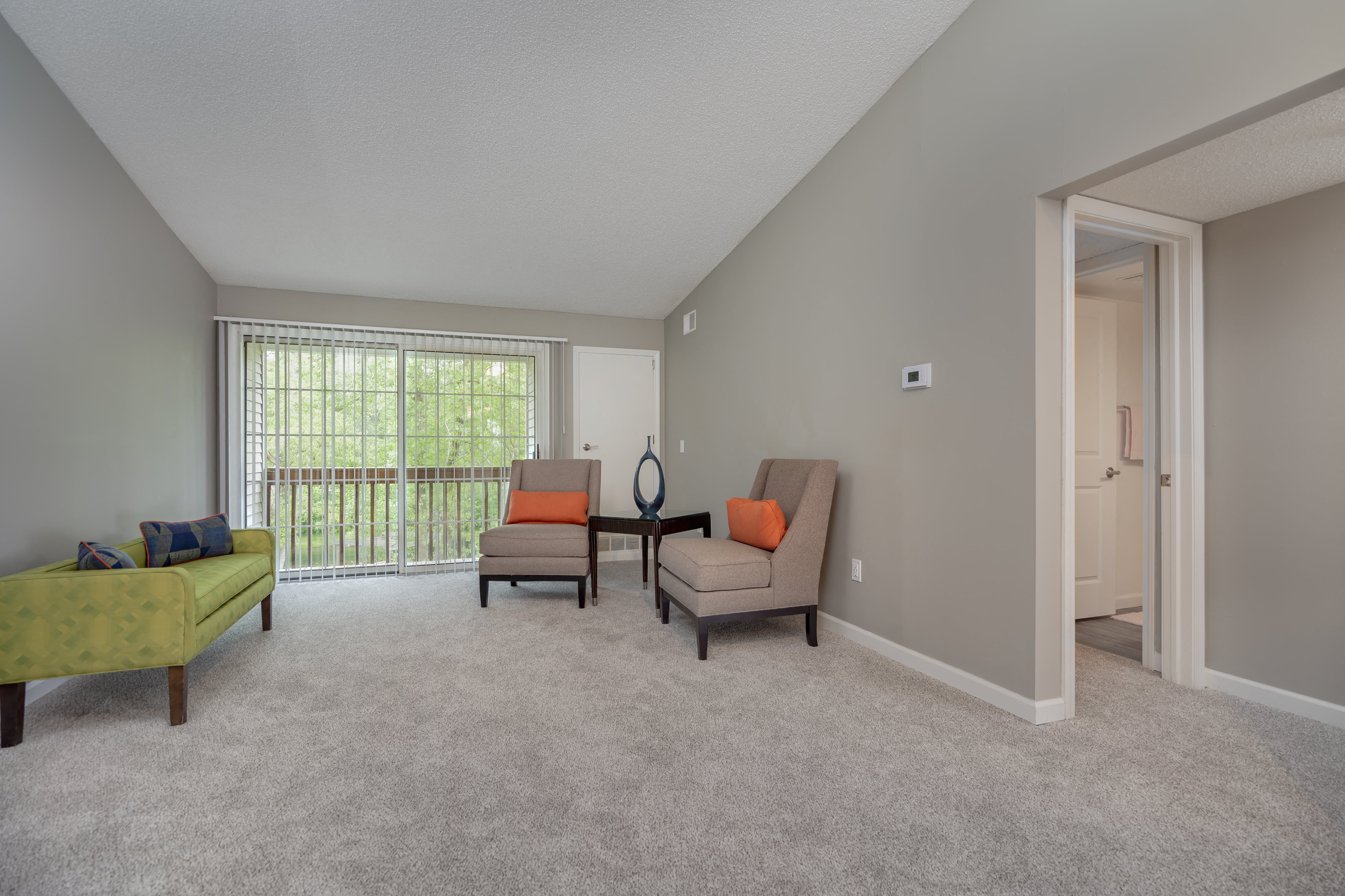 a living room with two chairs and a table in front of a window