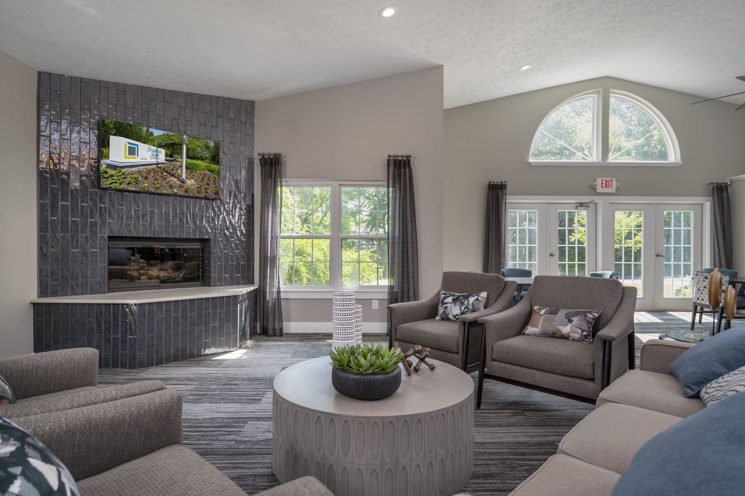 a living room with couches and chairs and a fireplace