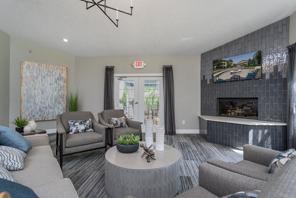 a living room with couches and a coffee table and a fireplace