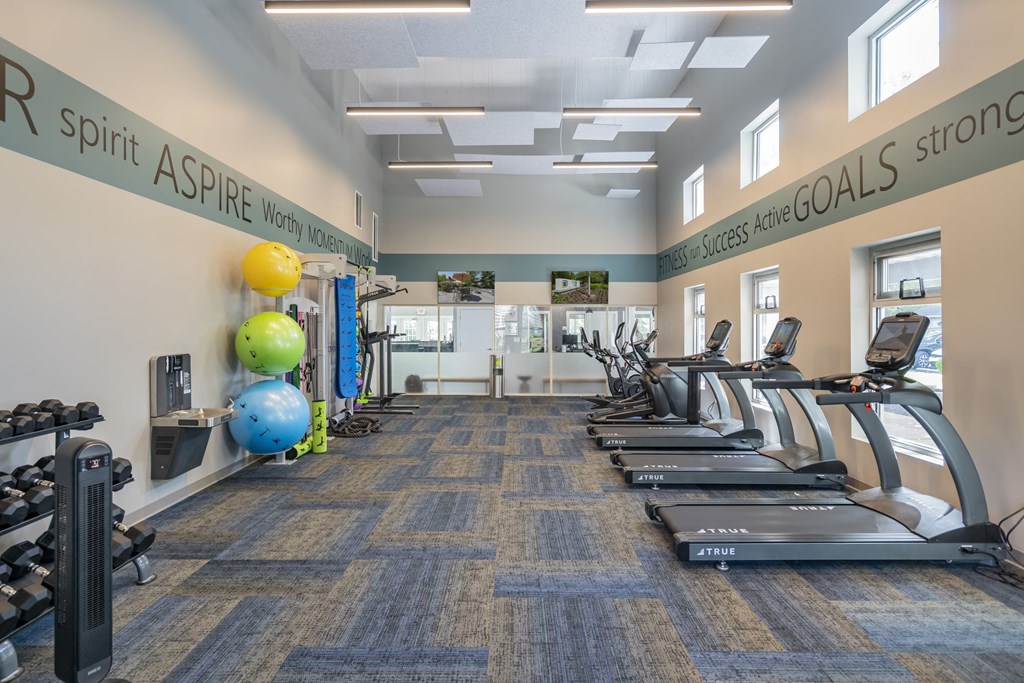 a gym with cardio equipment and treadmills at the heights