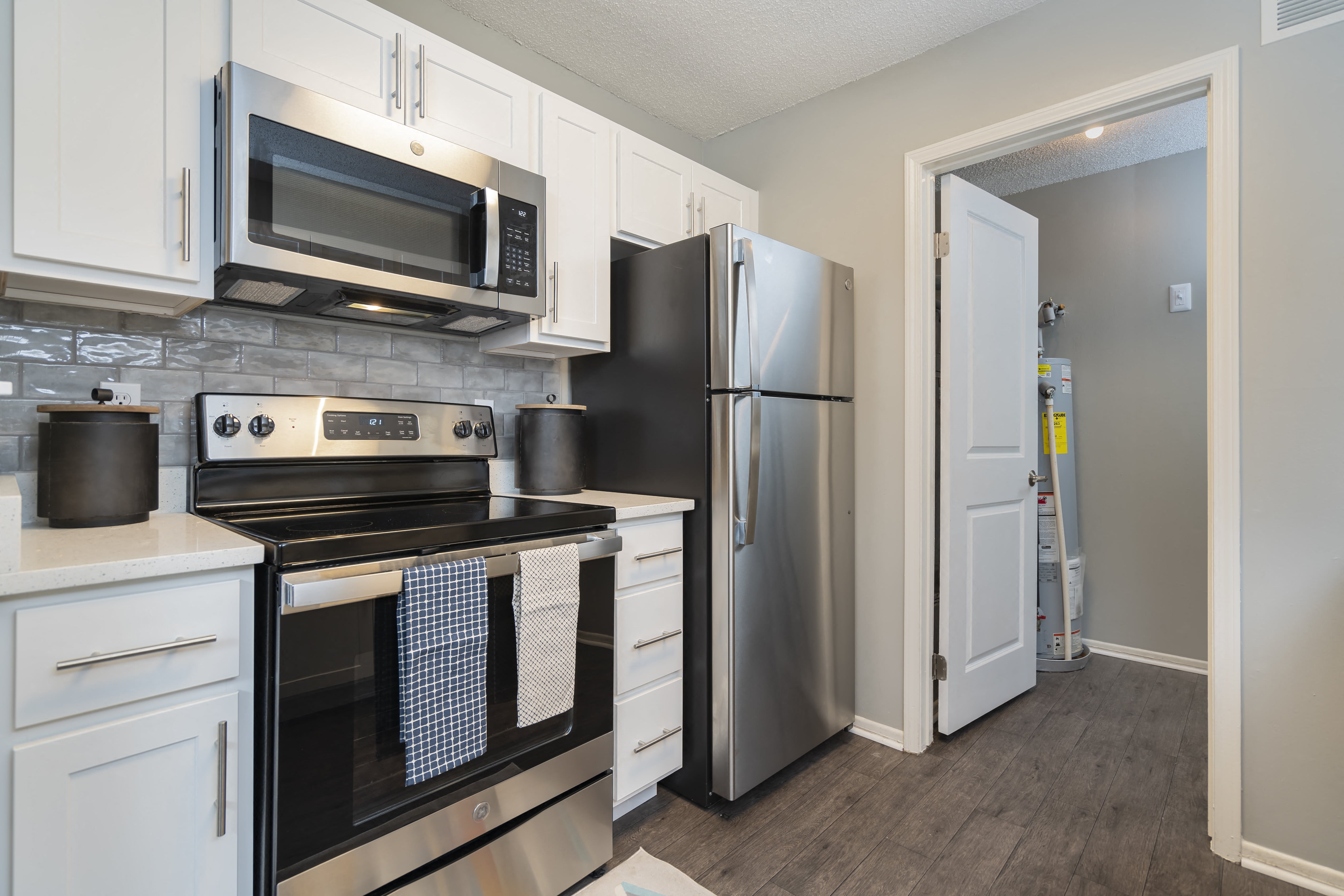 a kitchen with stainless steel appliances and white cabinets