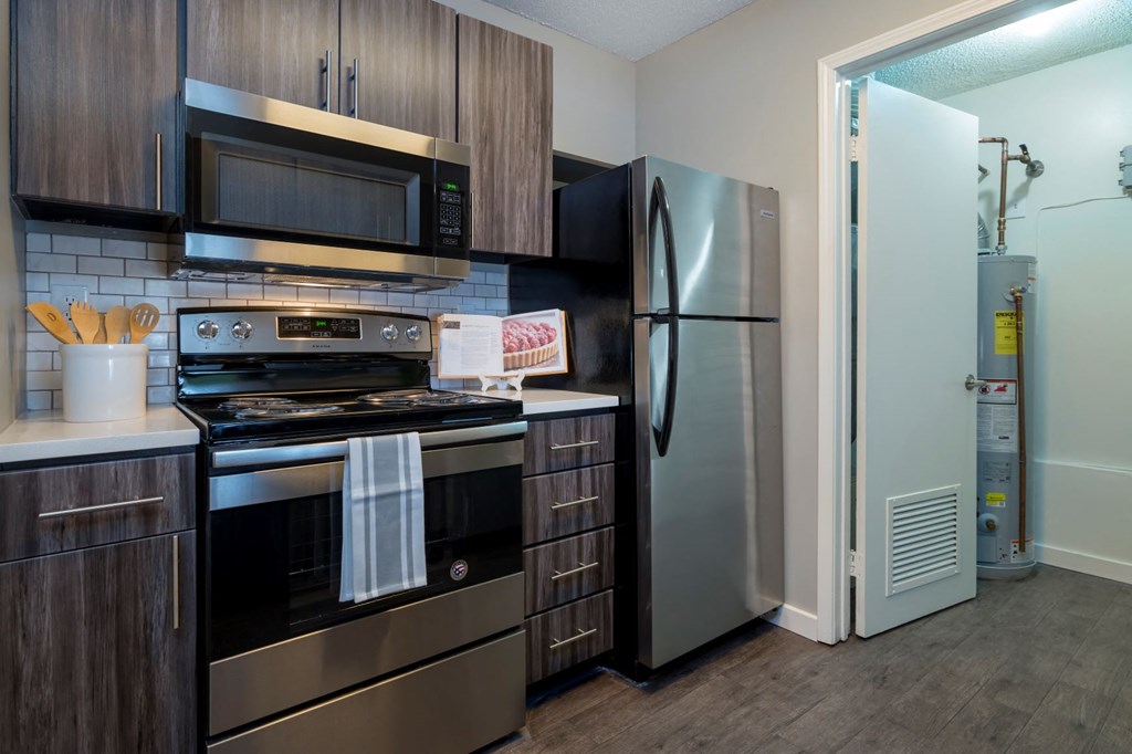 a kitchen with stainless steel appliances and a refrigerator