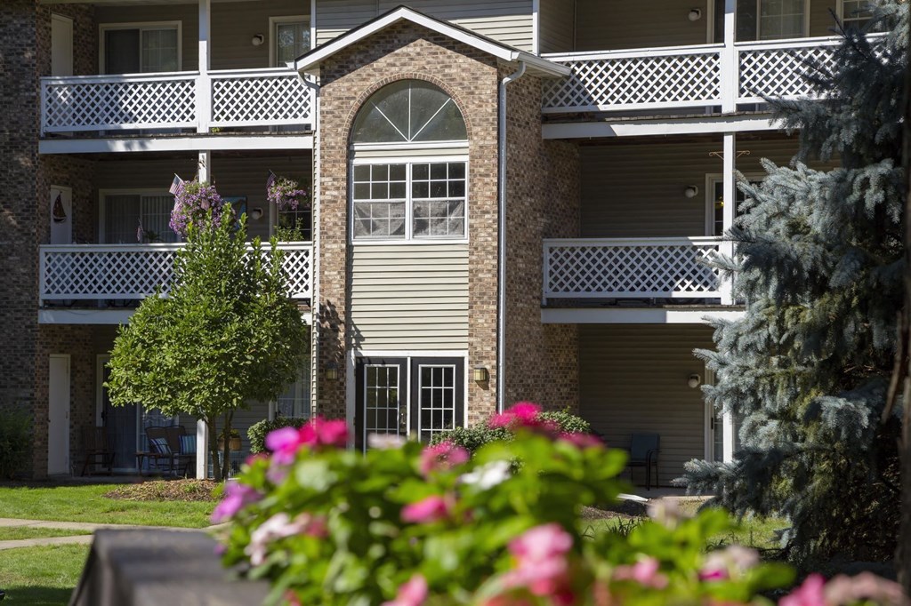 the view of a building with flowers in front of it
