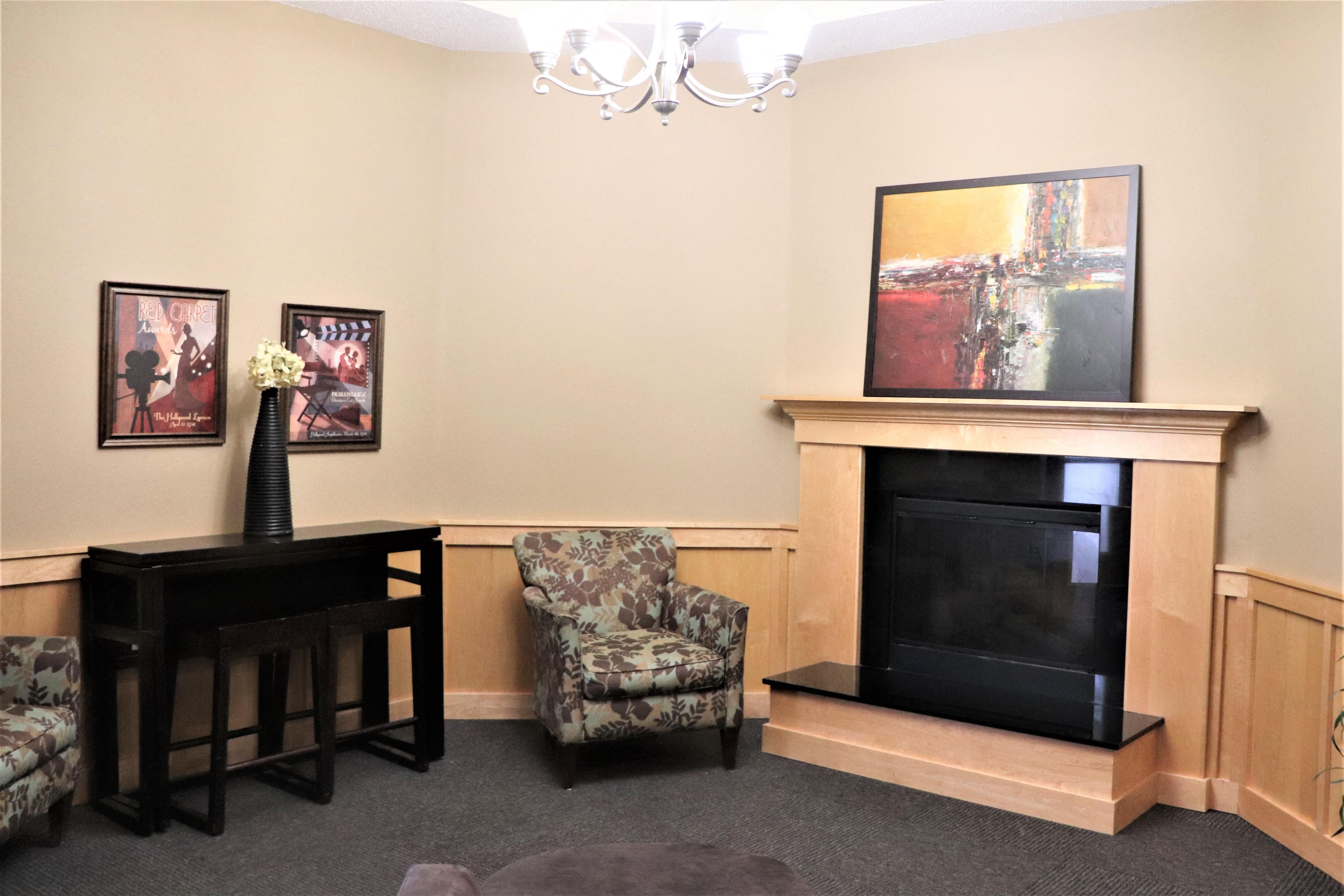 a living room with a fireplace and a table and chairs
