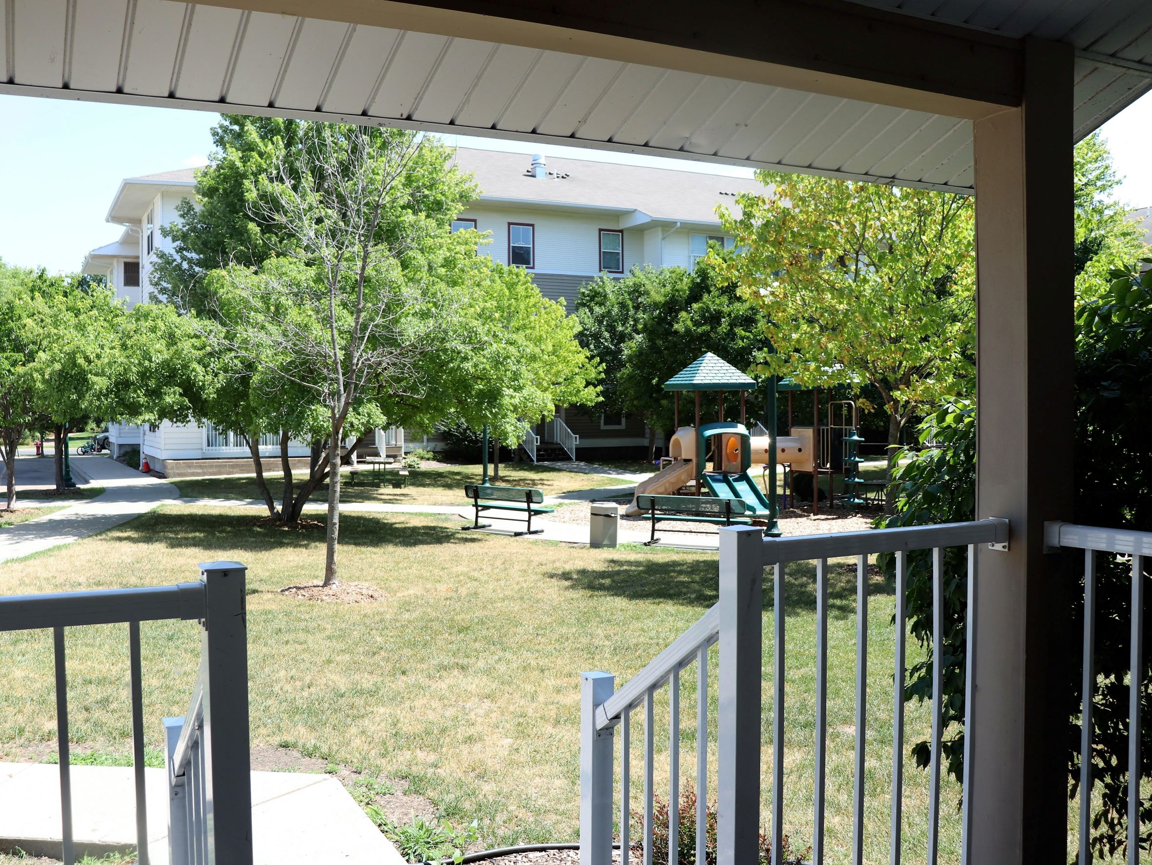 a view of the playground from the porch of a house