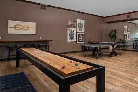 A room with a pool table and a shelf with a picture of a bunny on it.