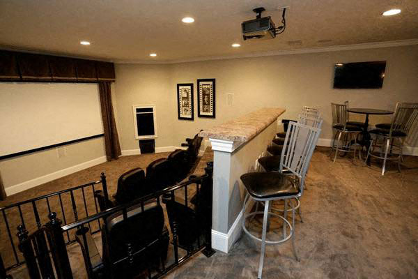 a living room with a bar and a table and chairs