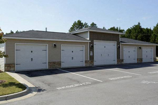 a building with three garages and a parking lot