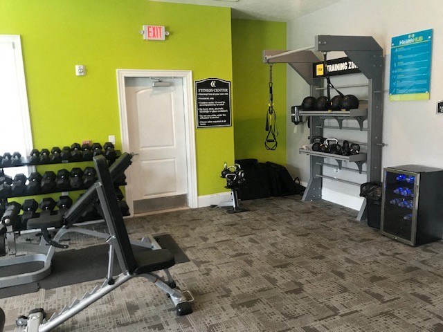 a gym with a bunch of weights on a rack