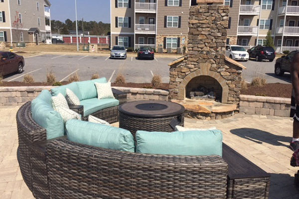 a patio with a couch and a fire pit