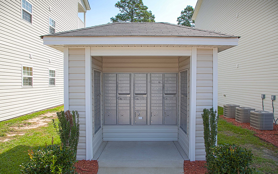 a small porch with a door to a white house