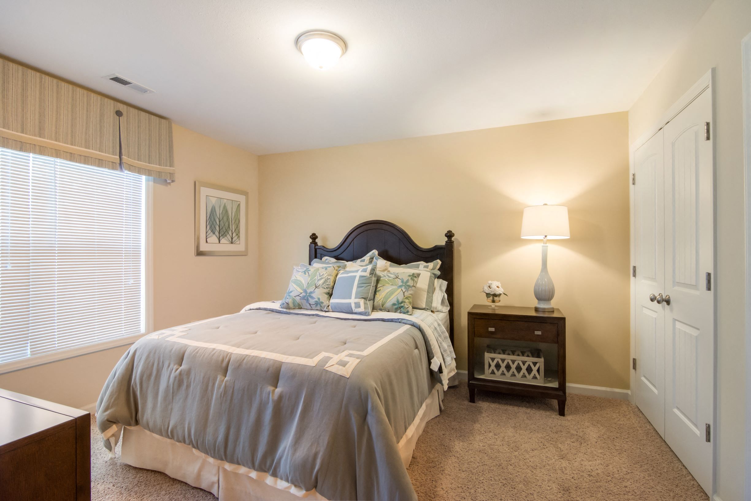 a bedroom with a bed and a night stand