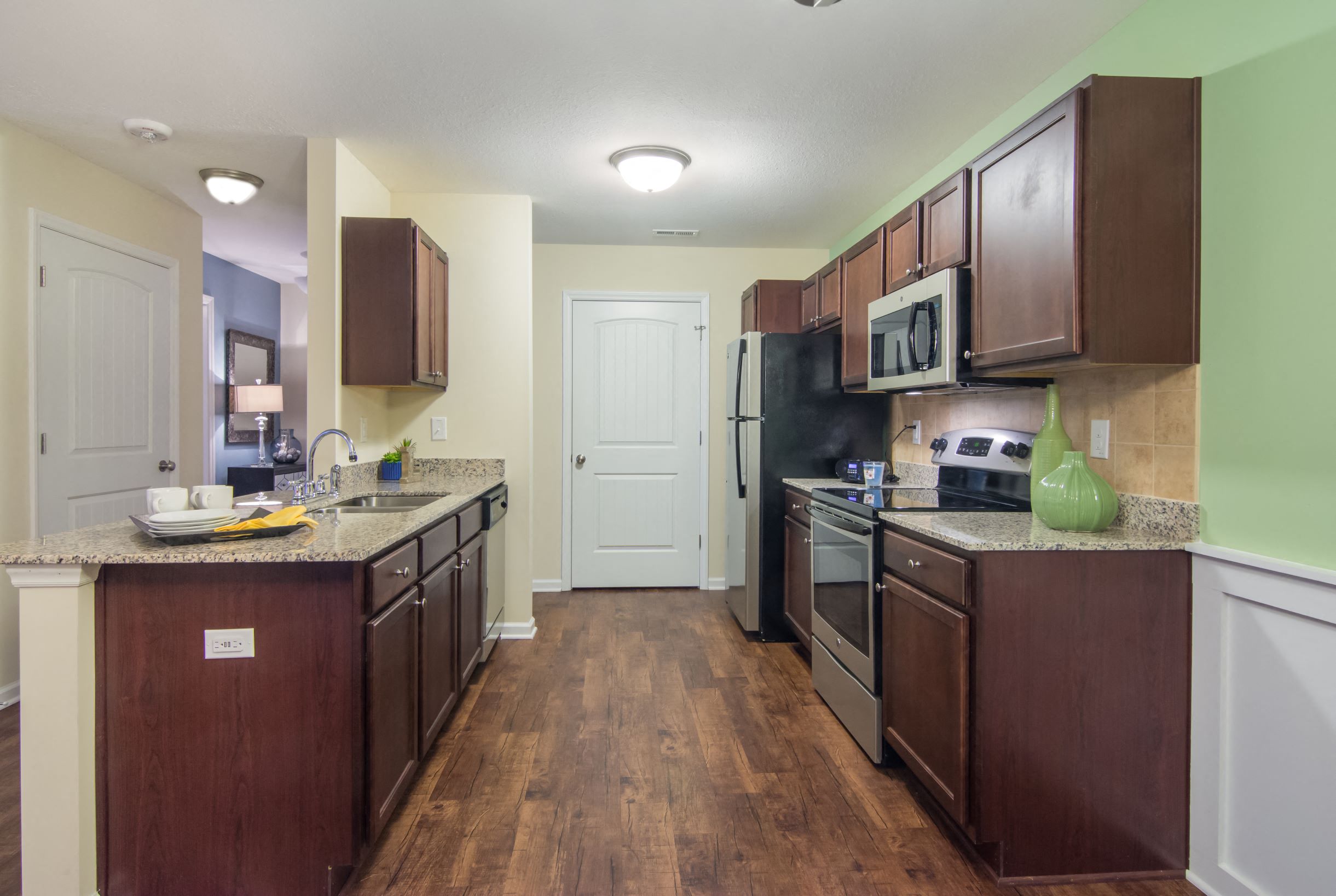 a kitchen with stainless steel appliances and wooden cabinets