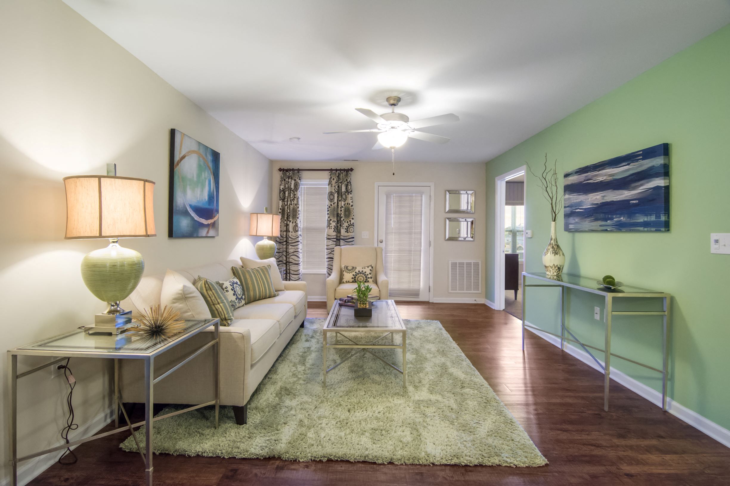 a living room with green walls and a white couch