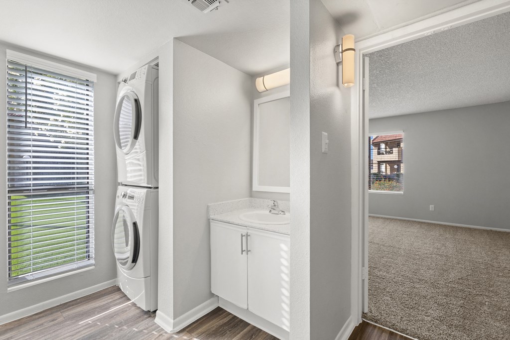 renovated bathroom with a washer and dryer at Sundancer Apartments, Tolleson, AZ