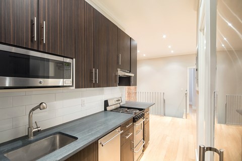 a kitchen with a sink and a stove and a microwave