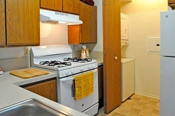Kitchen with Washer and Dryer Nook at Southport Apartments, Belleville, MI