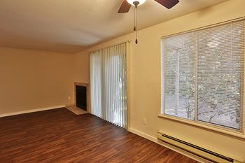 Spacious Model Floor Plan with Faux Wood Floor and Wood-Burning Fireplace at apartments in bremerton wa near naval base