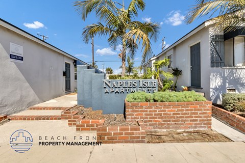the entrance to a building with a sign for the beach from property management