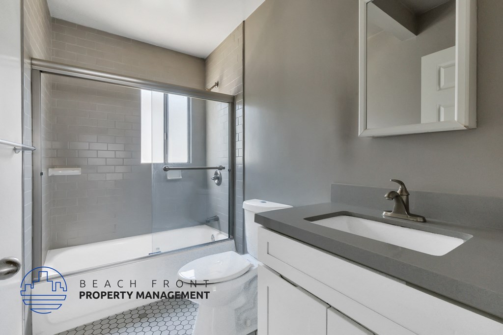 a bathroom with a sink and a toilet and a shower