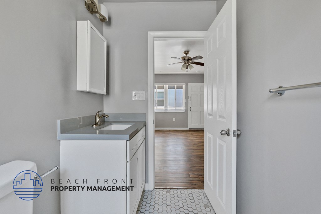 a small bathroom with a sink and a door to a hallway