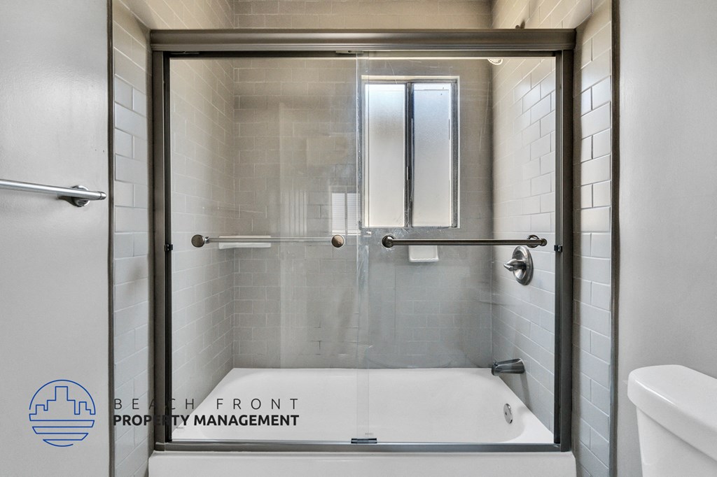 a bathroom with a shower with a glass door