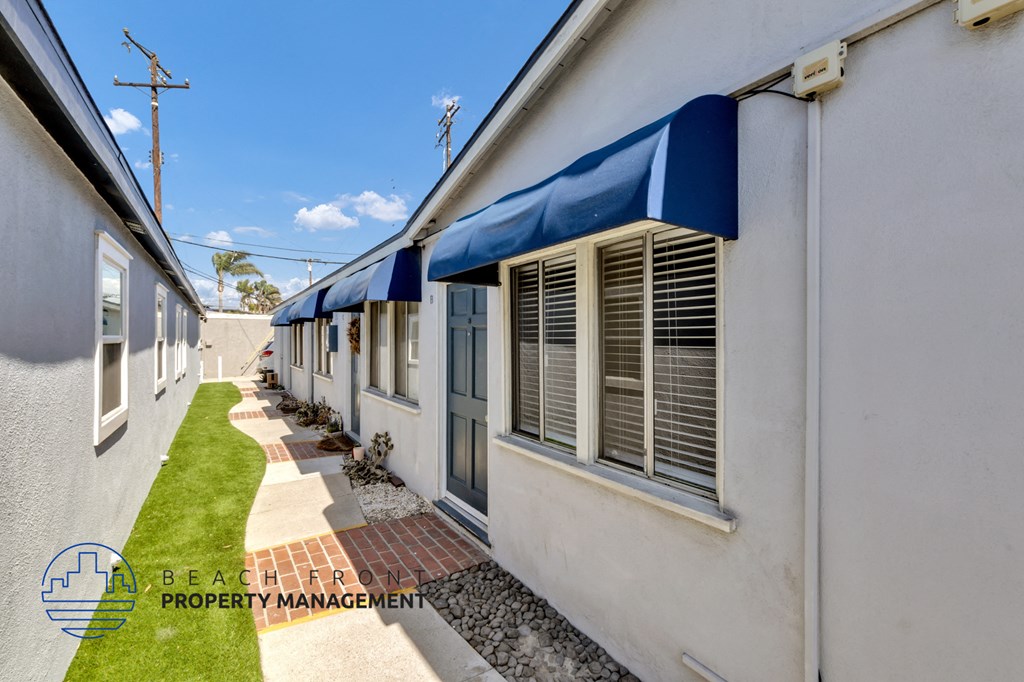 a view of the side of a building with windows and a blue awning