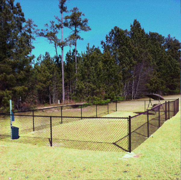 the park has a tennis court with a fence