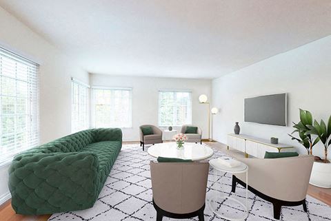 a living room with white walls and a green sofa
